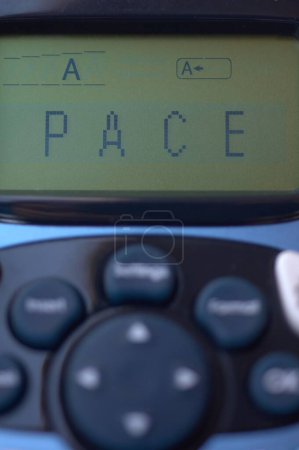 Image of a thermal printer with the word peace on the screen, symbolizing harmony in a digital context.