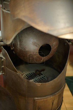 Close-up of an antique machine used in the chocolate making process, showing worn gears and mechanisms.