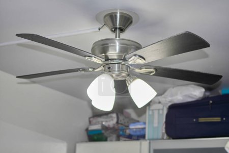 Photo for Elegant ceiling fan for a cool atmosphere and subtle lighting. - Royalty Free Image