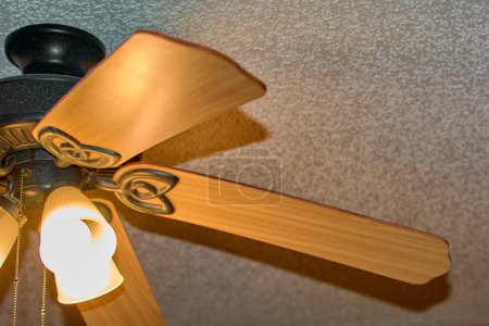 Photo for Golden ceiling fan with soft lighting, perfect for modern and stylish interiors. - Royalty Free Image
