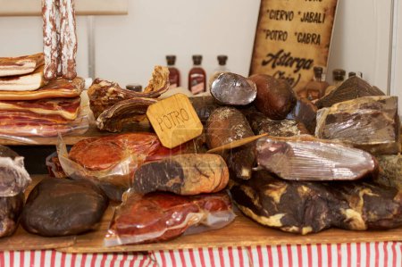 A selection of cured meats and sausages presented on a counter ideal for culinary arts and cultural cuisine.