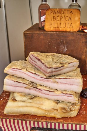 Close-up of stacked cured bacon, with a crystalline texture indicating salt curing. Ideal for highlighting quality and texture in the professional kitchen