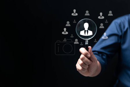 Headhunting, Recruitment and HRM all picking workers. Magnifier glass focus to manager icon which is among staff icons for human development recruitment leadership and customer target group concept.-stock-photo