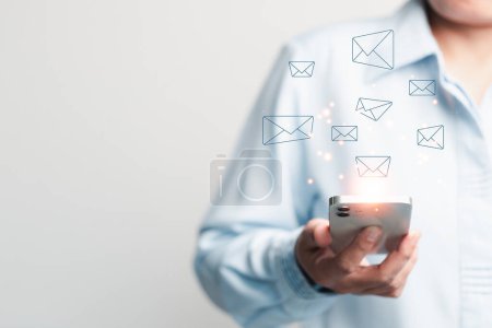 Photo for Businesswoman using phone and touching on virtual screen contact icons such as email, address, live chat, internet wifi. Contact us or Customer support hotline people connect. Connect with cyberspace. - Royalty Free Image