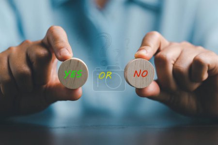 Photo for Concept of choice yes or no on wooden cubic blocks. Think with Yes or No choice, Business choices for difficult situations, Business woman hands holding two wooden with yes or no word on it. - Royalty Free Image