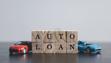 Photo for The word AUTO LOAN in the English language, written on wooden cubes. Finance and car loan, refinance, Investment and business concept with copy space. - Royalty Free Image