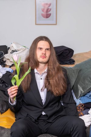 Photo for Confused, distracted and depressed man with long, brow hair look - Royalty Free Image