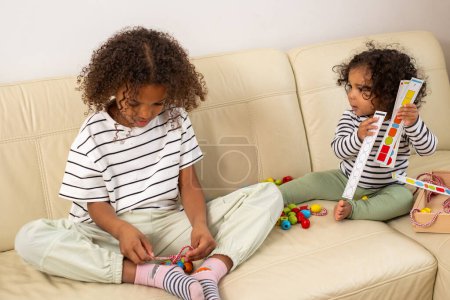 Two African American girls are absorbed in play with development provocative toys. engagement, and interest in learning perfect for kid occupation ideas. High quality photo