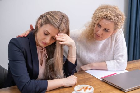 , a woman holds her head in despair across from an empathetic listener, capturing the challenge of facing bankruptcy and the crucial role of therapeutic conversation. High quality photo