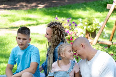 Captured in a natural park setting, a family enjoys the warmth of togetherness, celebrating the joys of National Siblings Day and parental love with active rest and engagement. High quality photo