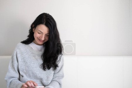 Cheerful middle aged woman with phone, is smiling, the epitome of joy in the digital age, finding humor in technology, and learning in midlife. High quality photo