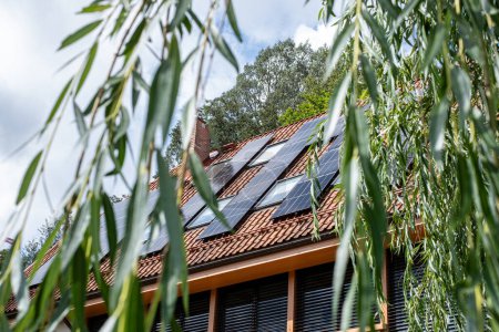 Eco friendly house with a solar-powered roof, harnessing the suns energy, represents a step towards green living and energy independence. High quality photo
