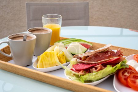 Breakfast on a terrace with panoramic views, offering a serene start to the day, suitable for showcasing luxurious bed and breakfast amenities. High quality photo