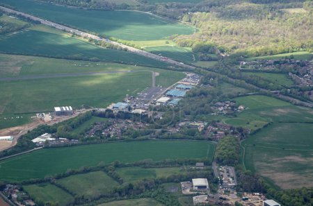 Foto de Aerial view of Wycombe Air Park in High Wycombe, Buckinghamshire with the M40 motorway running behind on a Spring afternoon. - Imagen libre de derechos