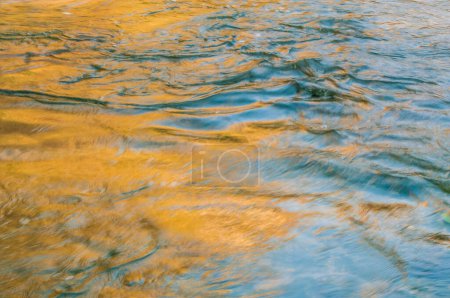 Foto de Colored river and rocks, colored reflection on water, colorful flowing water - Imagen libre de derechos