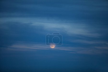 Photo for Moon hidden behind the clouds - Royalty Free Image