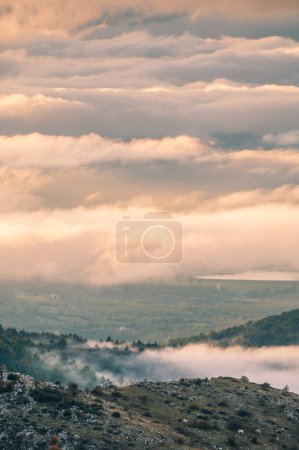 Photo for Fog and clouds on the valley at sunset - Royalty Free Image