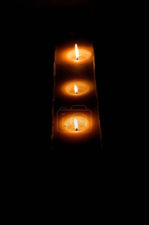 Photo for Group of burning candles on black background - Royalty Free Image