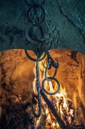 Photo for Stone chimney lit and chains - Royalty Free Image
