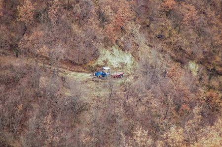 Photo for Aerial view of the tractor in the mountains, woodcutter deforestation - Royalty Free Image