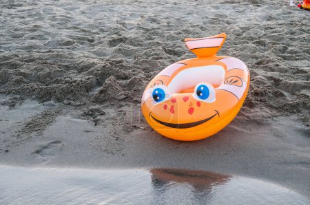 Photo for Orange inflatable boat on beach - Royalty Free Image