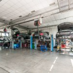 Interior of mechanical workshop with cars on lifts