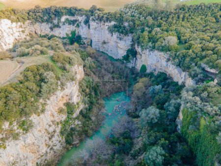 Photo for Gorges of the river Gravina, canyons carved into the rock with cultivated fields all around - Royalty Free Image
