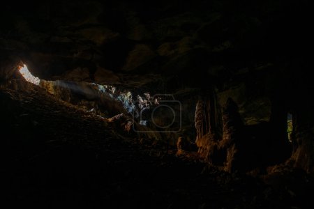 Photo for Cave lit by the sun's rays entering and illuminating the central chamber - Royalty Free Image