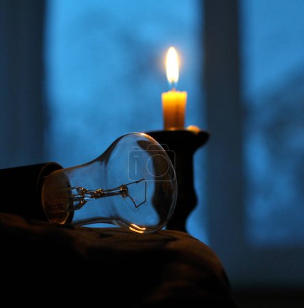 Photo for In the dark, when there is no electricity supply, a candle is lit - Royalty Free Image