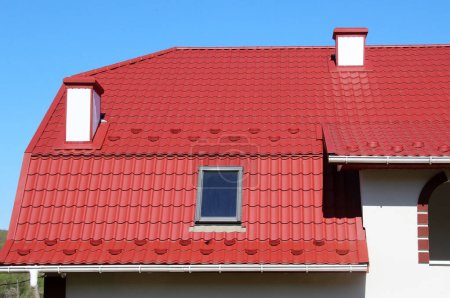 Photo for The house, the roof of which is covered with metal tiles - Royalty Free Image