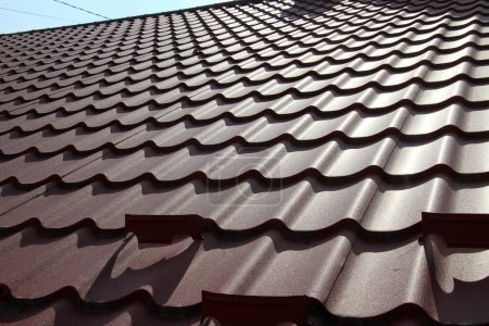 Photo for The house, the roof of which is covered with metal tiles - Royalty Free Image