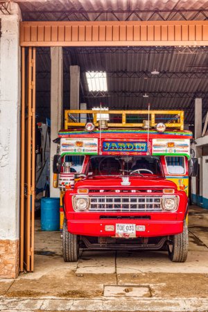 Photo for Jardin, Colombia - May 2019:Traditional colombian red chivas bus parked in garage - Royalty Free Image