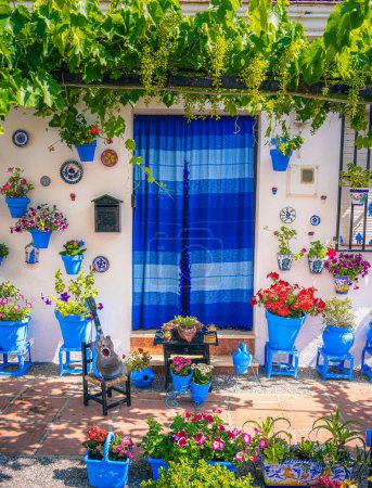 Photo for Iznajar de Cordoba, Spain. Houses adorned with vibrant plants as decoration. Streets filled with houses featuring abundant plant decorations. - Royalty Free Image