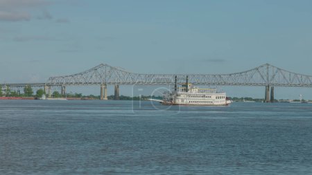 Photo for A wide shot of the paddlewheeler creole queen on the mississippi river in new orleans of louisiana, usa - Royalty Free Image
