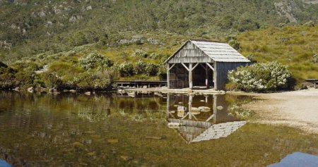 the old boat shed at dove lake on a calm summer morning at cradle mountain national park of tasmania, australia