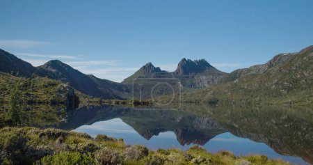 dove lake with glacier rock and cradle mt in the distance on a calm summer morning at cradle mountain national park of tasmania, australia