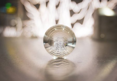 close up of a small crystal ball on the floor at a subway station 