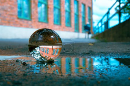 Close up of a crystal ball in a puddle 