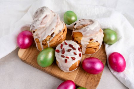 Photo for Easter cruffin cake and colored green and red Easter eggs - Royalty Free Image