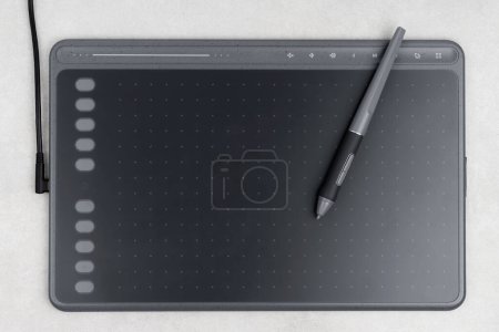 Photo for Top view of drawing tablet and stylus on grey background - Royalty Free Image