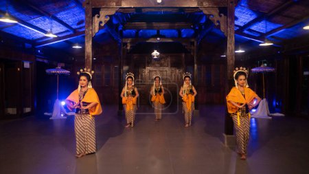 Photo for A group of Javanese dancers are dancing a traditional dance in an old building at night - Royalty Free Image