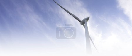 Foto de Blurred banner windmill farm or wind park, with high wind turbines for generation electricity. Green energy generating concept. Sustainable development, renewable energy, winter, copy space - Imagen libre de derechos