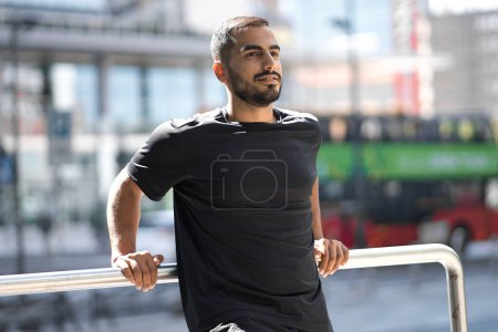 Photo for Handsome bearded man looking at distance and smiling outdoors alone. Positive lifestyle concept - Royalty Free Image
