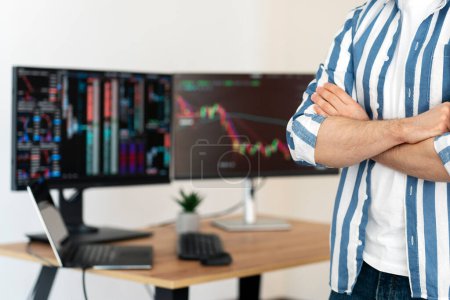 Photo for Cropped view of crypto trader holding arms crossed standing in modern office, monitors with crypto chart on background, selective focus. Successful business, online trading concept - Royalty Free Image