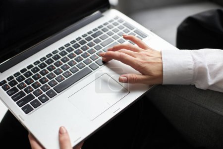 Photo for Closeup view of the caucasian businesswoman typing email, programmer is develops software - Royalty Free Image