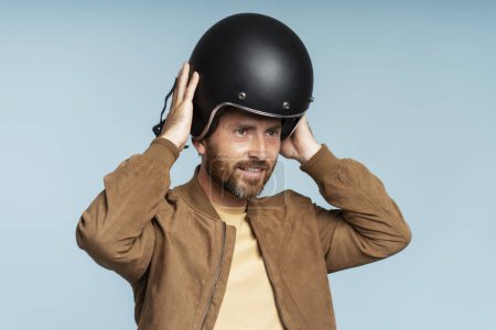 Photo for Handsome bearded biker wearing motorcycle helmet isolated on blue background. Adventure, freedom, road trip concept - Royalty Free Image