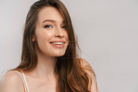 Photo for Close up portrait of beautiful smiling woman with toothy smile looking at camera after dental procedure. Attractive fashion model with natural makeup on face isolated on grey background - Royalty Free Image