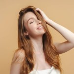 beautiful woman touching hair isolated on background