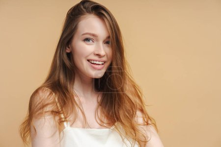 Photo for Close up portrait of beautiful smiling woman with toothy smile looking at camera after dental procedure. Attractive fashion model with natural makeup on face isolated on beige background - Royalty Free Image