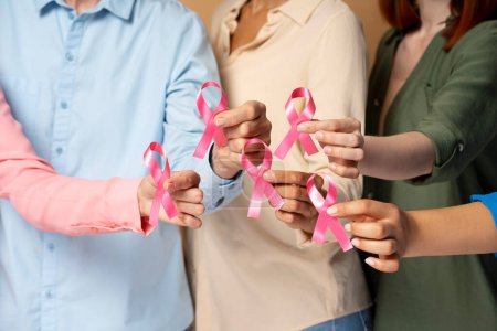 Women hands holding pink ribbon isolated on background. Health care. Breast cancer awareness month
